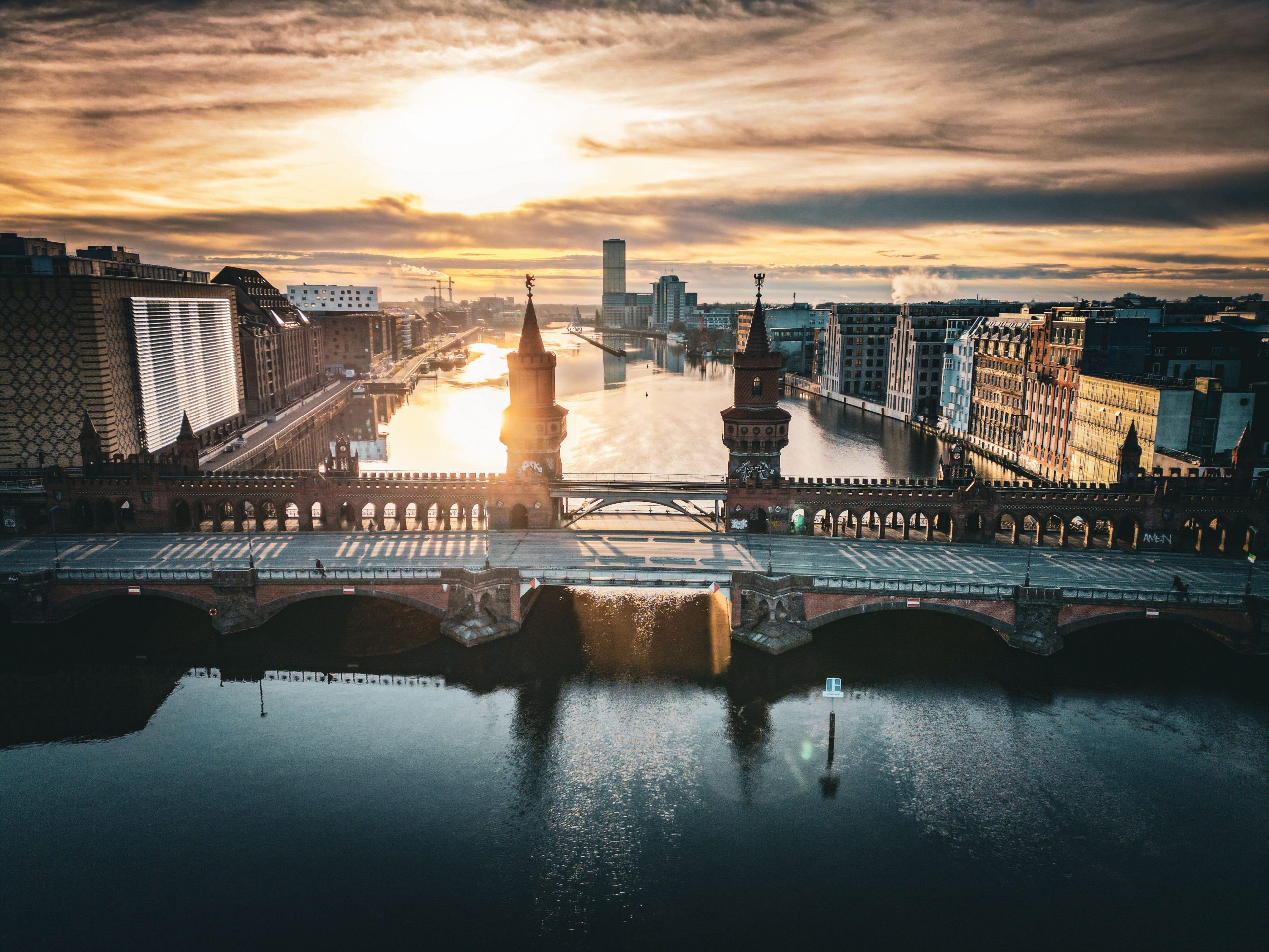 Oberbaumbruecke ueber der Spree bei Sonnenuntergang in Berlin.